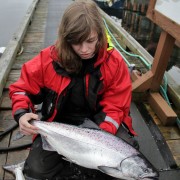 Kitty Holding Her Catch at the Dock