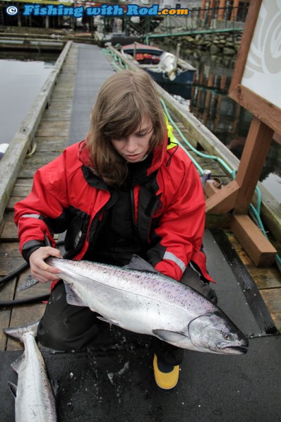 Kitty Holding Her Catch at the Dock